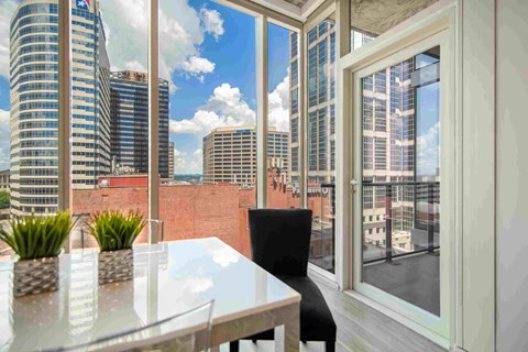 a dining room with a view of the city and a table and chairs