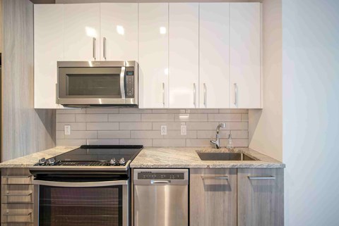 a kitchen with stainless steel appliances and white cabinets