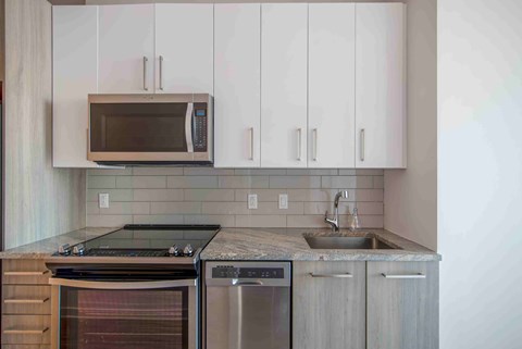 a kitchen with stainless steel appliances and white cabinets