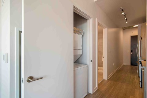 a pass through door into a laundry room with a washer and dryer