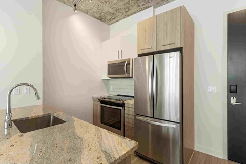 a kitchen with stainless steel appliances and granite counter tops