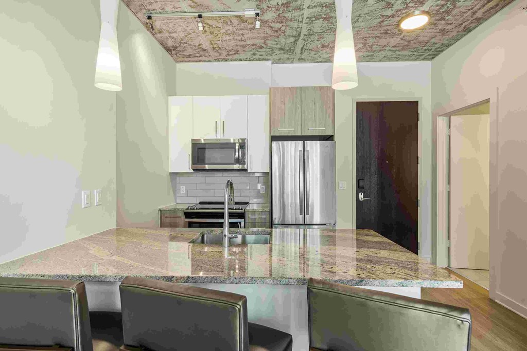 an empty kitchen with a granite counter top