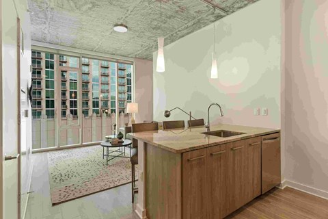 a large kitchen with a large island and a door to the living room