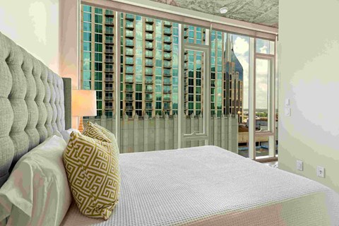 a bedroom with a bed and a door to a balcony