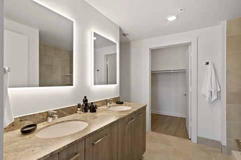 a bathroom with two sinks and two mirrors