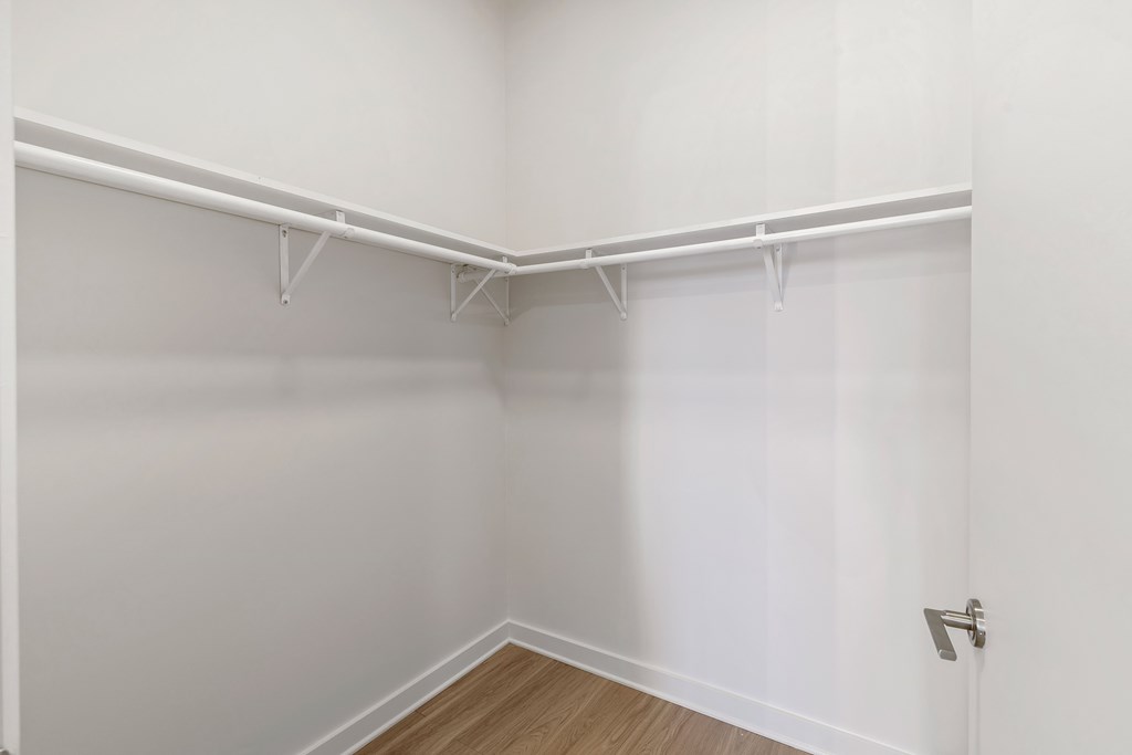 an empty room with white walls and a wood floor