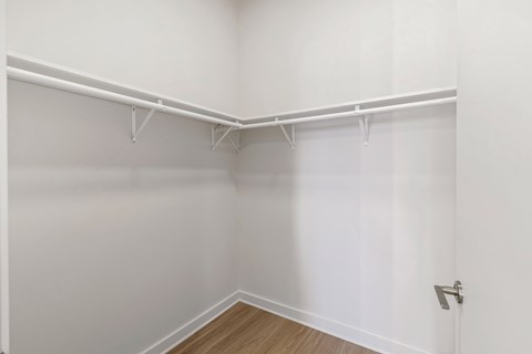 an empty room with white walls and a wood floor