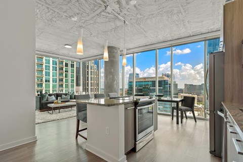 a kitchen with an island and a view of the city