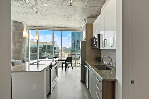 a kitchen and living room with a city view