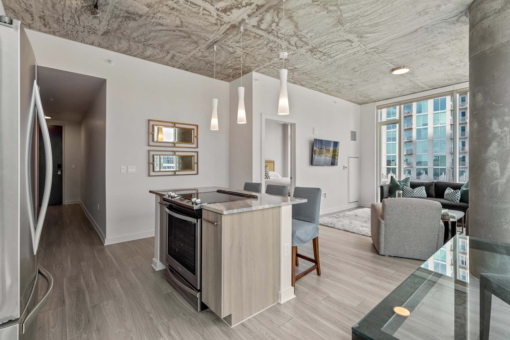 a kitchen and living room with an island in the middle