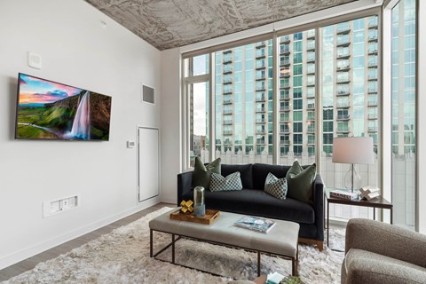 a living room with a large window and a couch and a table