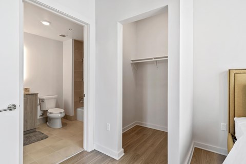 a bedroom with a bathroom with a toilet and a closet