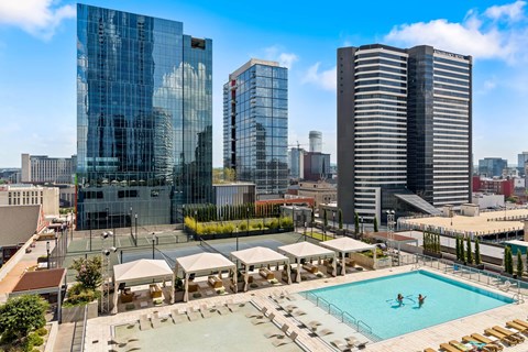 an aerial view of a swimming pool and the city
