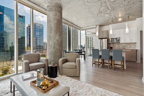 a living room with a city view and a table and chairs