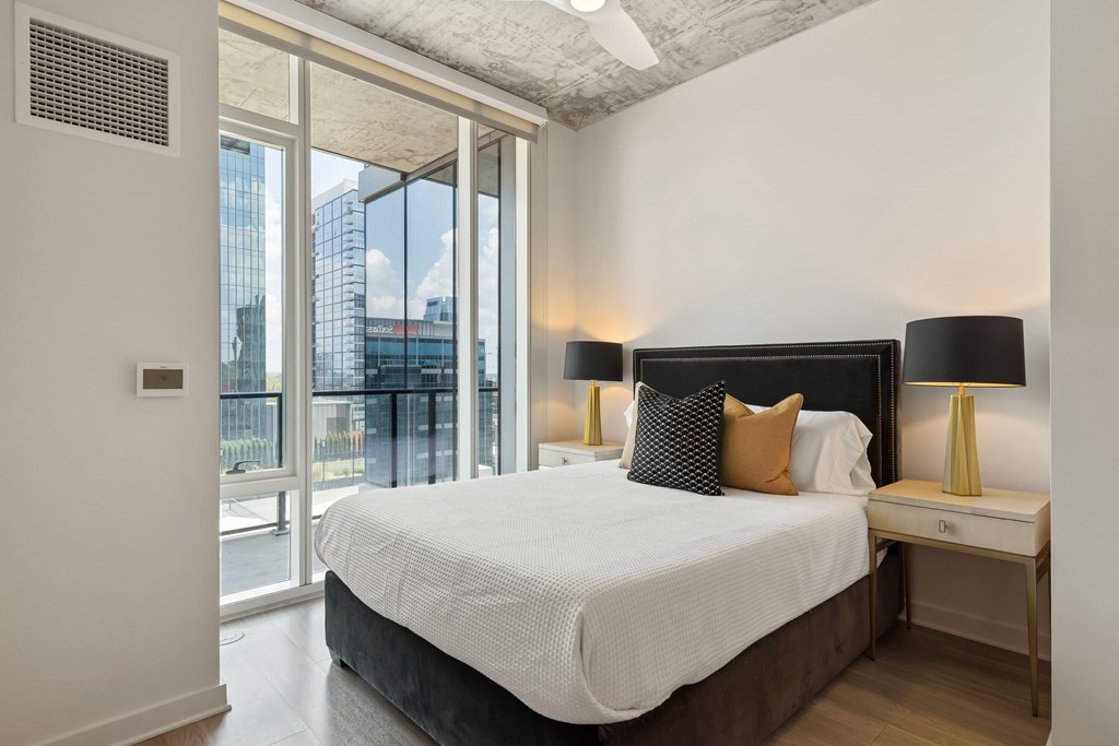 a bedroom with a large bed and a large window