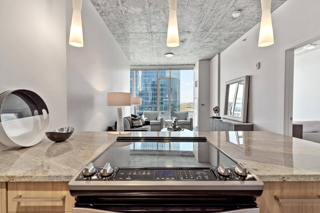 a kitchen with a large island and a view of a living room