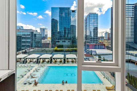 a view of a pool and a city from a window