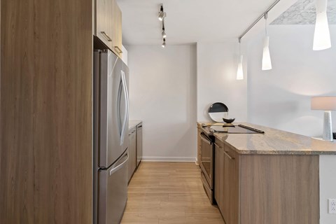 a kitchen with wooden cabinets and stainless steel appliances