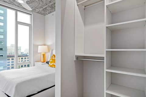 a bedroom with a bed and a large window