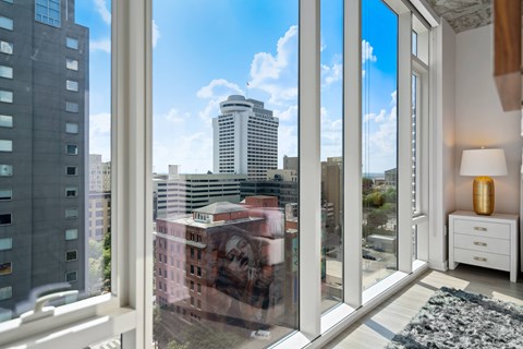 a view of the city from a living room with large windows