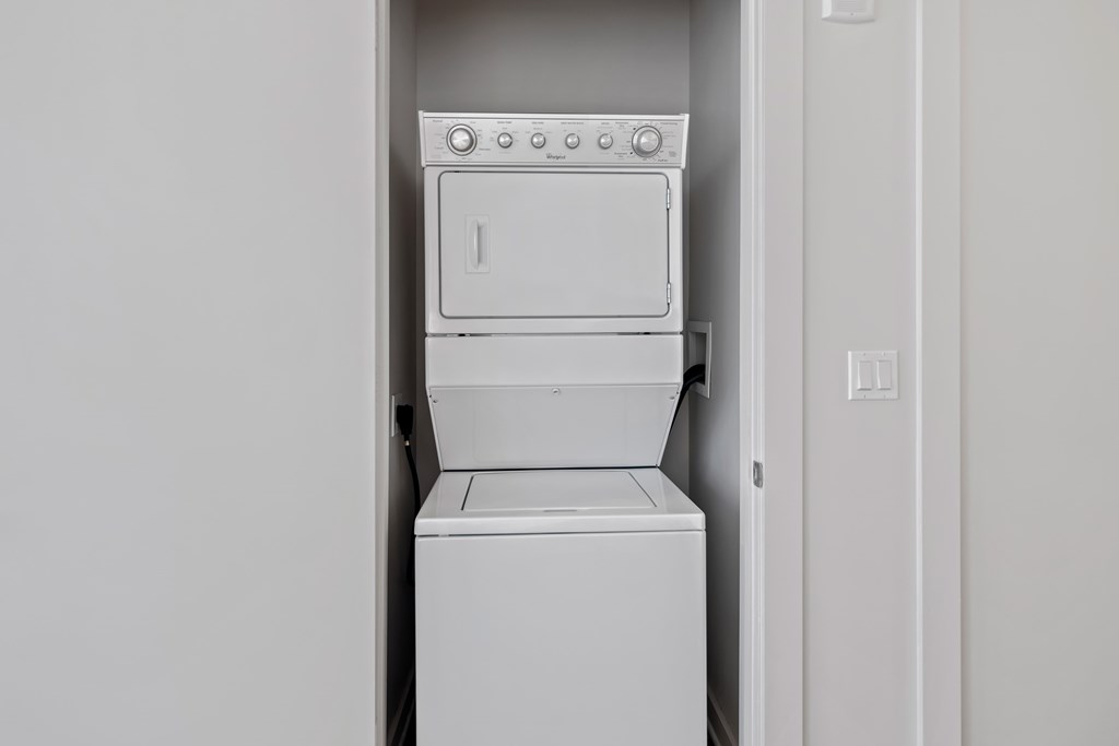 an empty laundry room with a washer and dryer