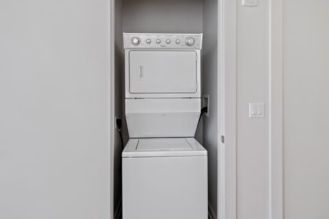 an empty laundry room with a washer and dryer