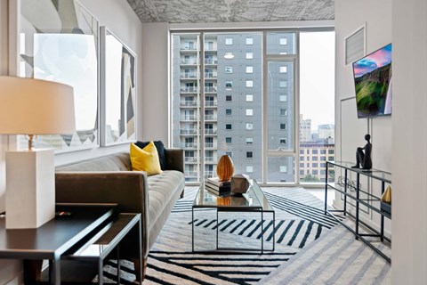 a living room with a large window and a white couch