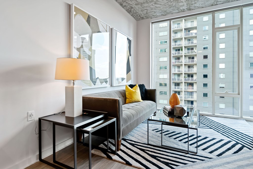 a living room with a large window and a couch