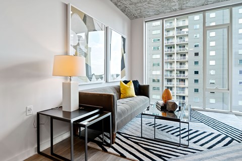 a living room with a large window and a couch