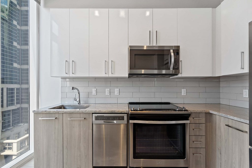 a kitchen with stainless steel appliances and white cabinets