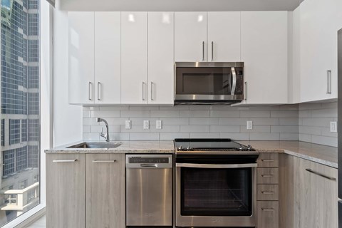 a kitchen with stainless steel appliances and white cabinets