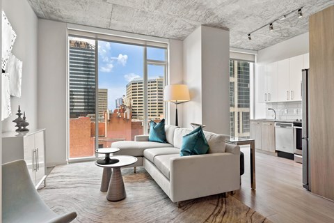 a living room with a couch and a view of the city