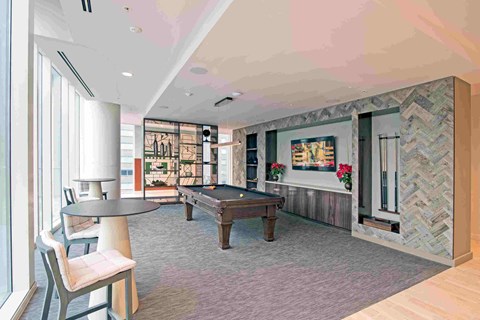 a games room with a pool table and a bar