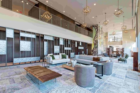 a lobby of a hotel with couches and chairs