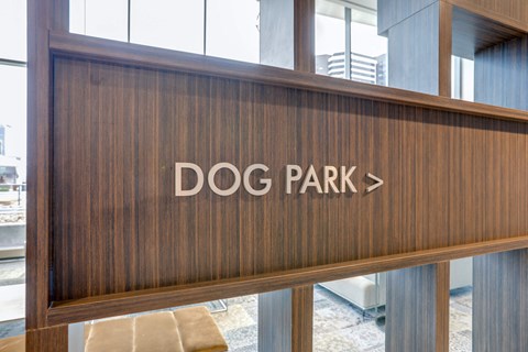 a sign for dog park on the front of a building