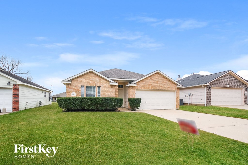 a house with a driveway and a lawn