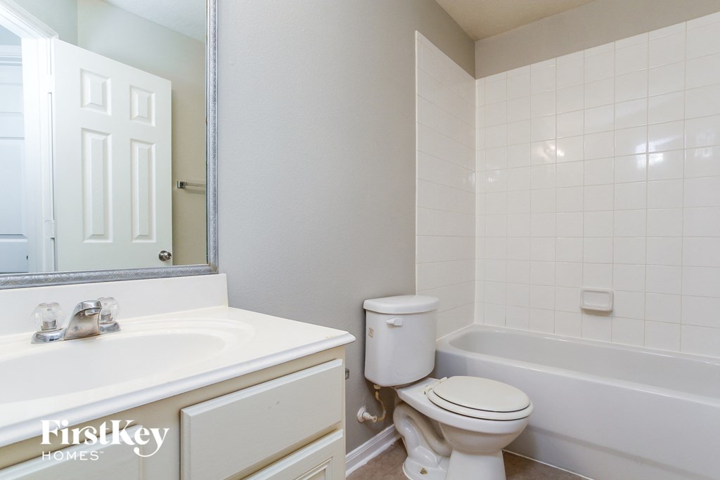 a bathroom with a toilet and a sink and a tub