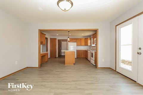 A kitchen with wooden cabinets and a white refrigerator is shown in a FirstKey Homes property.