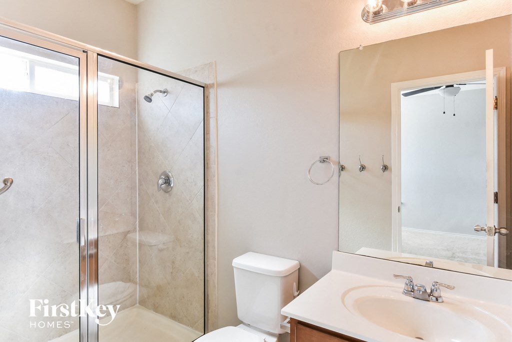 a small bathroom with a shower toilet and sink