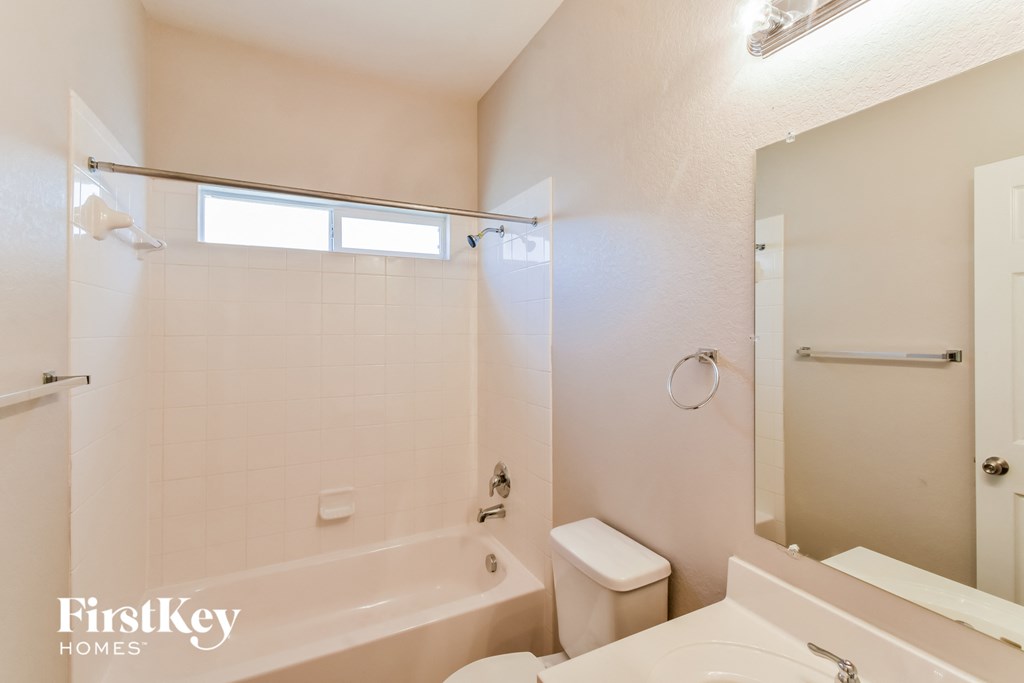 a bathroom with a tub and a toilet and a sink