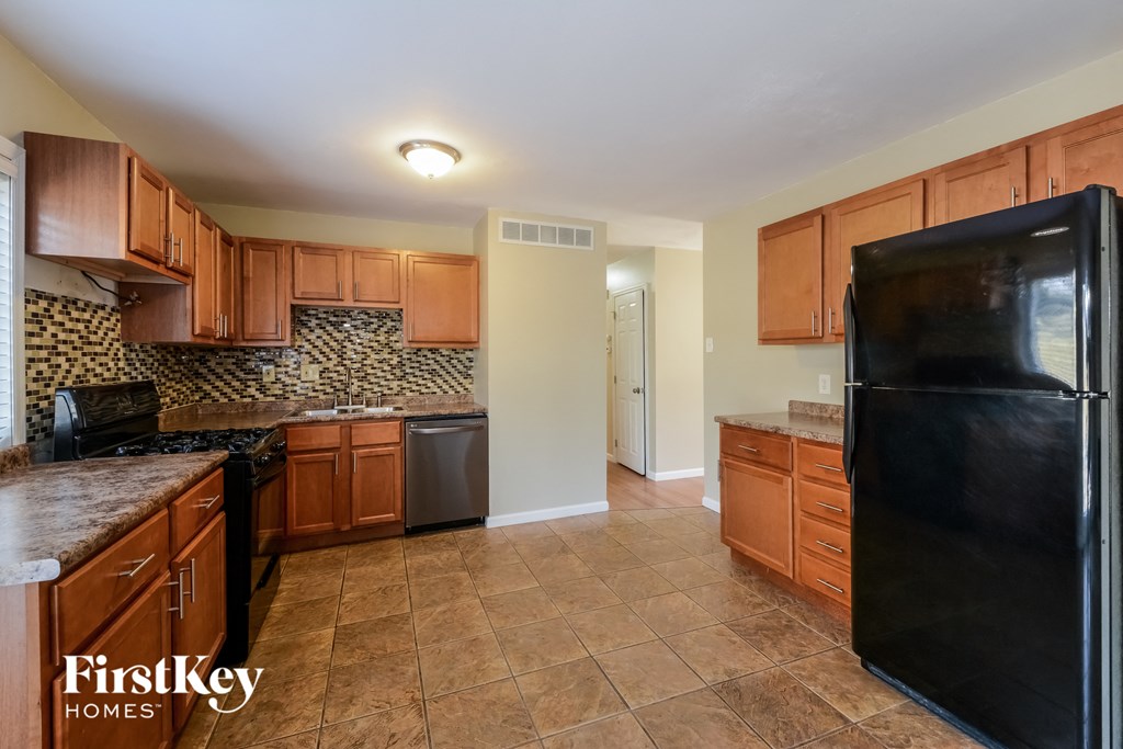 a kitchen with black appliances and wooden cabinets