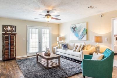 Newly renovated living room with ample seating and ceiling fan at The Reserve of Byram apartments for rent in Byram, NJ