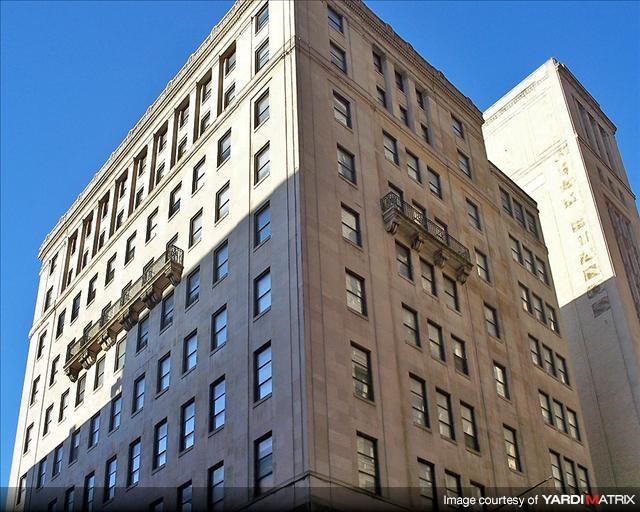 a tall building with a lot of windows and a blue sky