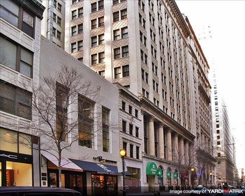 a tall building on the corner of a city street