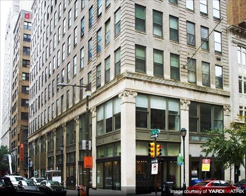a tall building on the corner of a city street