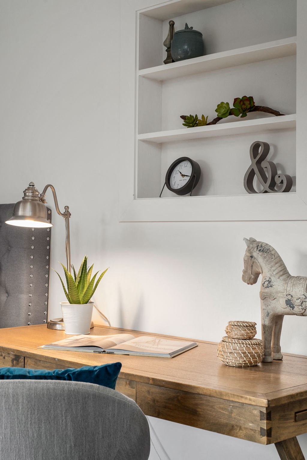 a home office with a desk and a horse statue