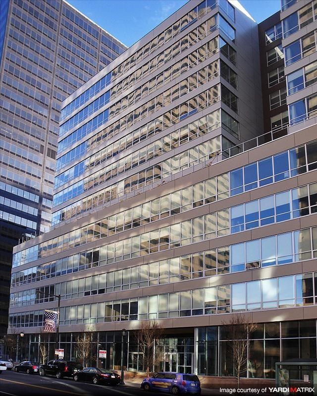 a tall building with cars parked in front of it