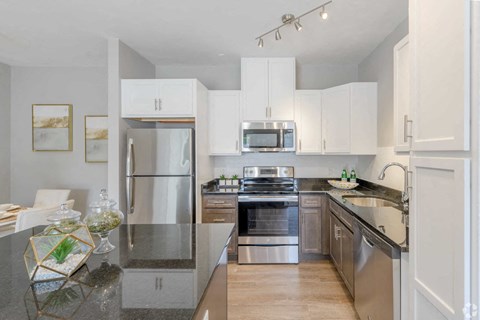 a kitchen with stainless steel appliances and white cabinets