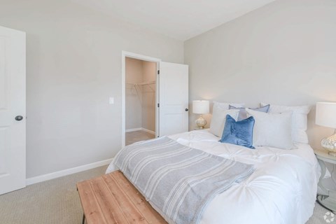a bedroom with a bed and a closet