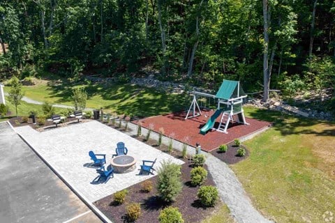 a backyard with a playground and a picnic table